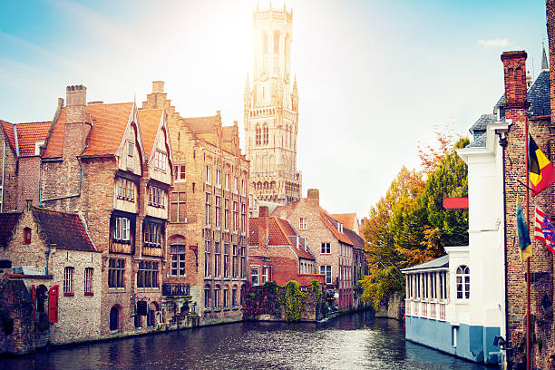 Waterfront Buildings in Bruges, Belgium View to the canals and Bell Tower of Bruges brugge belgium stock pictures, royalty-free photos & images