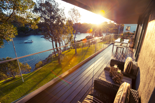Waterfront house balcony at sunset