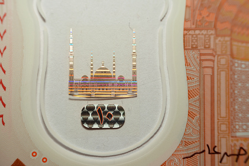 Colorful watermark of the administrative capital's grand mosque Al-Fattah Al-Aleem in Egypt from the obverse side of the new first Egyptian 10 LE EGP ten pounds plastic polymer banknote series 2022