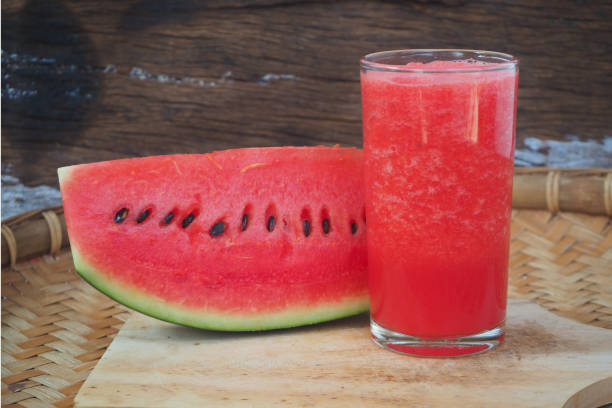 Watermelon juice Healthy watermelon smoothies,watermelon juice with slices on wooden background watermelon juice stock pictures, royalty-free photos & images