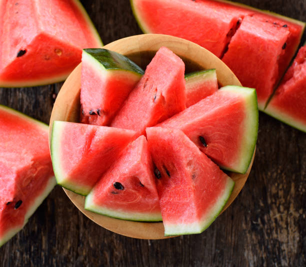 watermelon sliced on wooden background stock photo