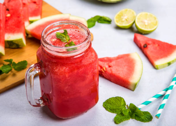 Watermelon Smoothie In A Jar With Mint And Lemon Watermelon Smoothie In A Jar With Mint And Lemon watermelon juice stock pictures, royalty-free photos & images