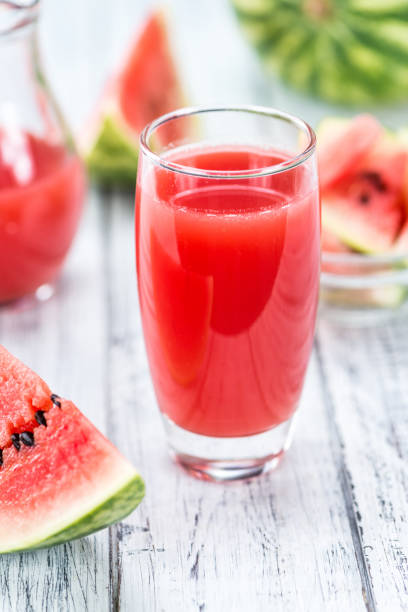 Watermelon Smoothie (selective focus) Watermelon Smoothie on a vintage background as detailed close-up shot (selective focus) watermelon juice stock pictures, royalty-free photos & images
