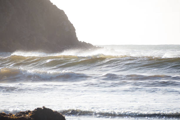 Waves and rocky headland stock photo