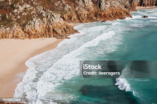 istock Waves breaking into the Coastline of Porthcurno in Cornwall, South West England 1149852366