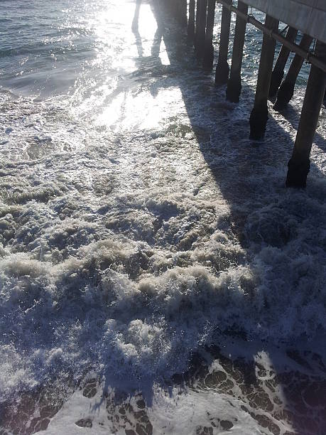 Waves under a Pier in santa Monica, ca stock photo