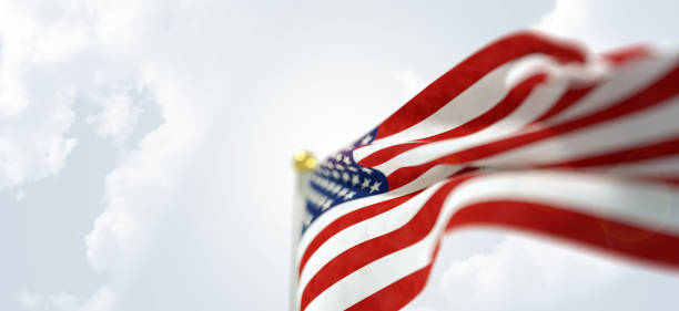 Waving American flag horizontal on sky background
