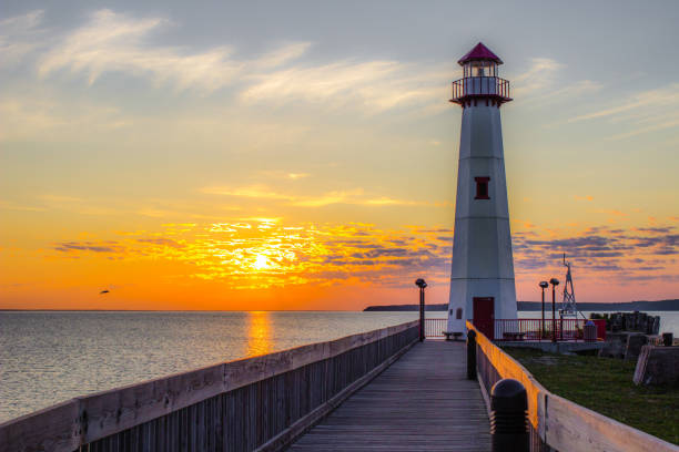 Wawatam Lighthouse In St Ignace Michigan At Sunrise Beautiful sunrise over the Straits of Mackinaw at the Wawatam Lighthouse in the small town of St Ignace in the Upper Peninsula of Michigan. mackinac island stock pictures, royalty-free photos & images