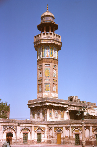 One of the minarets, part of the highly decorated Wazir Khan Mosque in Lahore.  Built in the 17th Century.  There are four of these octagonal  minarets at the corners of a rectangular courtyard, all with outstanding 'kashi-kari' tile work.  Recorded on Kodachrome - the date created is approximate