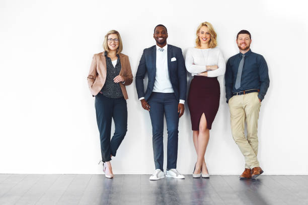 We all have something in common, success Shot of well-dressed businesspeople standing against a white background businesswear stock pictures, royalty-free photos & images