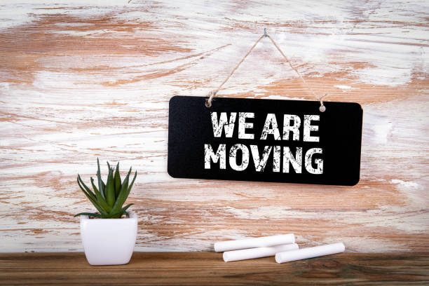 We Are Moving. Small blackboard on the wall stock photo