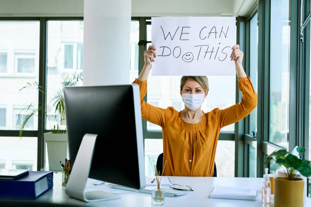 We can do this! Businesswoman holding placard with we can do this text as support during virus epidemic. xdo stock pictures, royalty-free photos & images