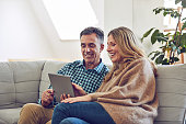 Shot of a mature couple using a tablet together at home