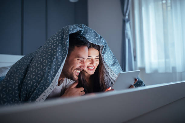 Couple Watching Movie In Bed Stock Photos, Pictures &amp; Royalty-Free  Images . Valentine's Day, valentine's day date, date night, movie night, valentine's 2022