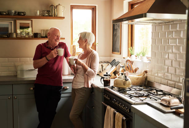 We enjoy life sip by sip Cropped shot of a senior couple spending quality time together at home domestic kitchen photos stock pictures, royalty-free photos & images