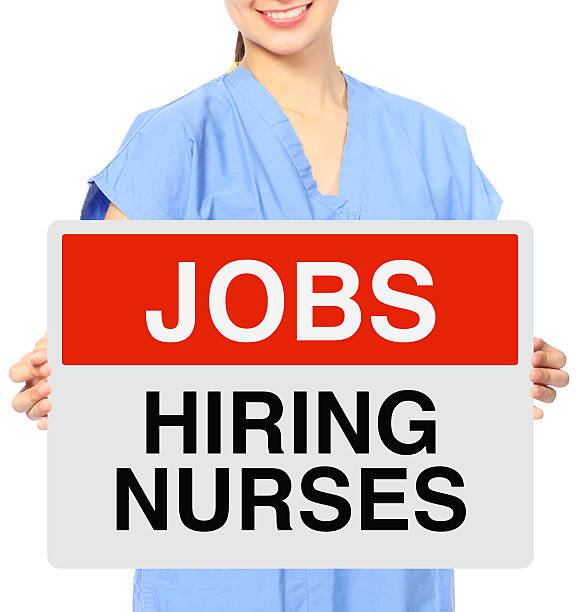 We Need Nurses A medical person holding a recruitment sign wanted signal stock pictures, royalty-free photos & images