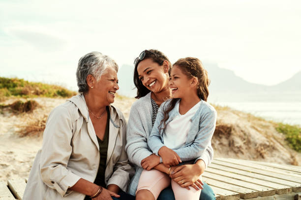 We see so much of ourselves in her Shot of an adorable little girl spending the day with her mother and grandmother at the beach multi generation family stock pictures, royalty-free photos & images