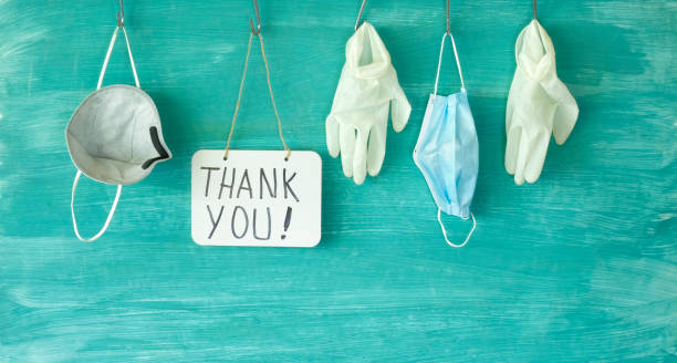 We thank the medical staff  for their devoted work during cornavirus epidemic, symbolic picture,medical gloves, face masks and the message Thank you stock photo