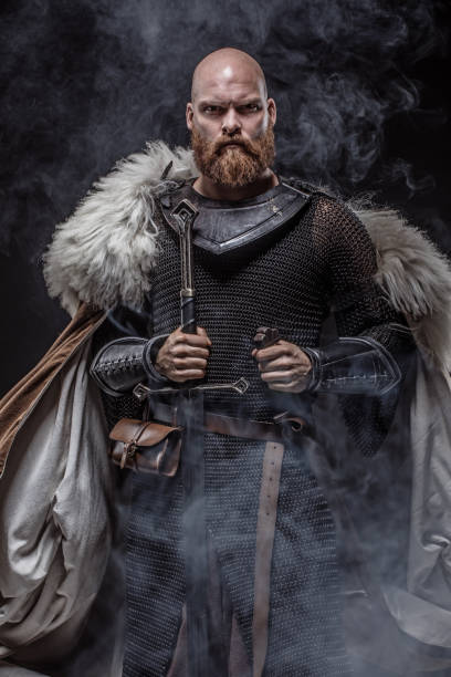 Weapon wielding redhead viking warrior in studio shot stock photo