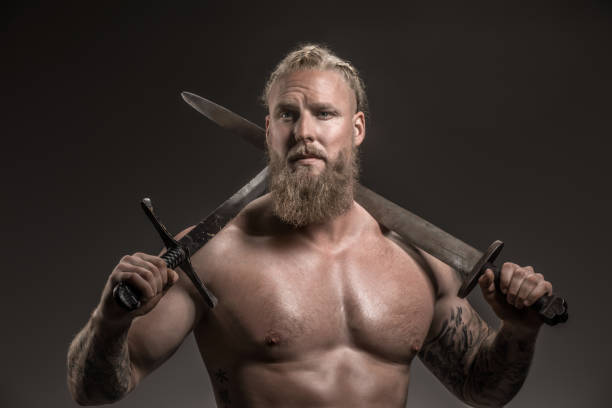 Weapon wielding viking warrior in studio shot stock photo