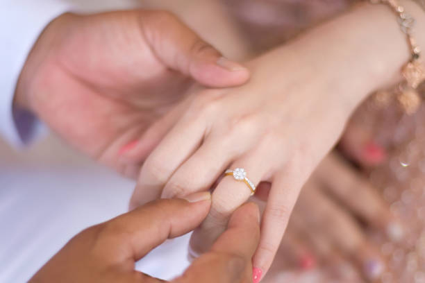 wearing a ring at a wedding stock photo
