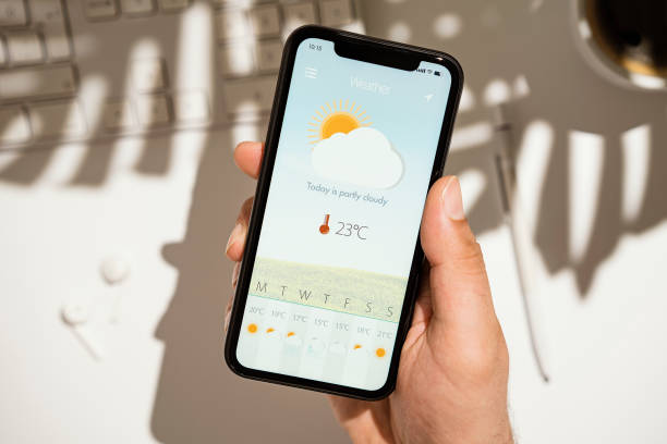 Weather forecast app on smart phone screen stock photo