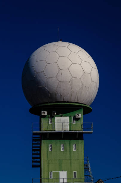 Weather station with a large white sphere in blue sky. stock photo
