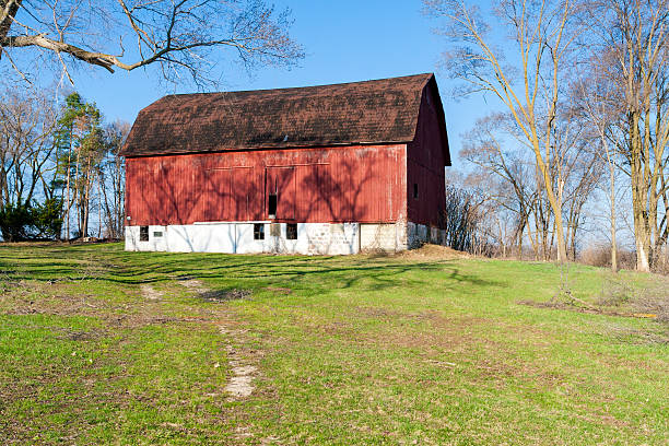 Weathered red barn on a hill stock photo