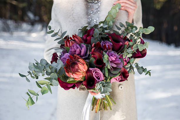 Wedding bouquet in hands of the bride Wedding bouquet in hands of the bride. Winter time, snowy fores bouquet stock pictures, royalty-free photos & images