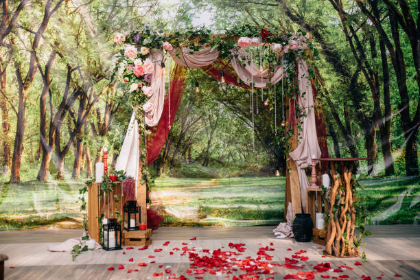 Wedding ceremony arch, altar decorated with flowers on the lawn stock photo