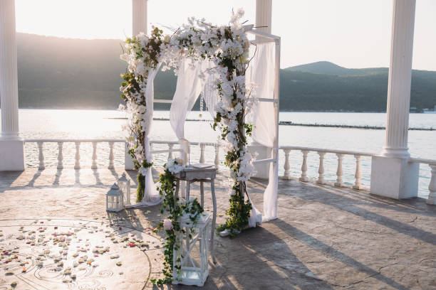 Wedding ceremony arch it the beautiful lake place. Details of decoration stock photo