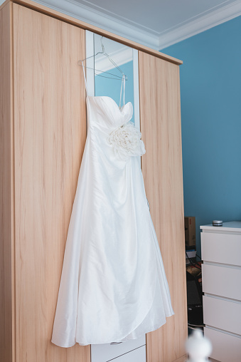 Wedding Dress On A Hanger In The Brides Room Stock Photo