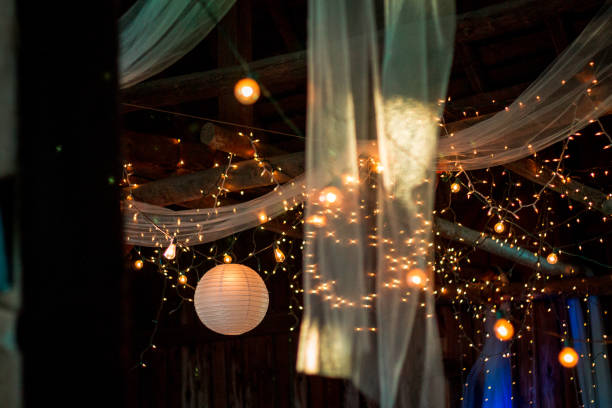 Wedding reception lighting at a barn wedding in the summer stock photo