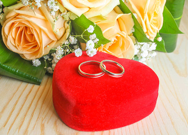 wedding rings wedding rings on a heart shaped box  and  flowers wedding ring box stock pictures, royalty-free photos & images