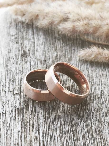 Wedding rings with dry wood and grain stock photo