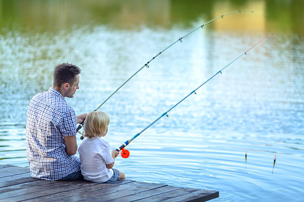 Weekend Dad and son fishing at lake fishing stock pictures, royalty-free photos & images