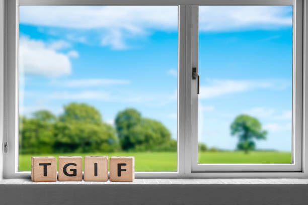 TGIF weekend sign in a white window stock photo