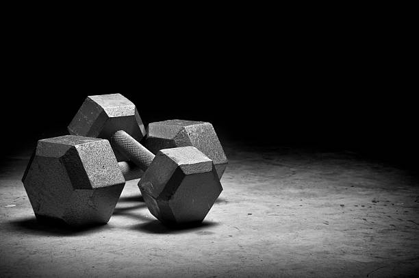 Weight lifting Dumbbells isolated on grunge surface. Please see my portfolio for other sport related images. dumbbells stock pictures, royalty-free photos & images