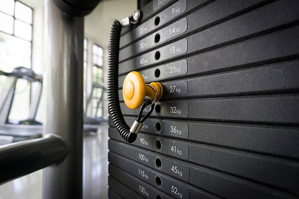 Weight Training Weight Training exercise machine stock pictures, royalty-free photos & images