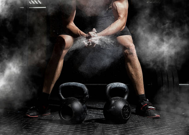 Weightlifter clapping hands and preparing for workout at a gym stock photo