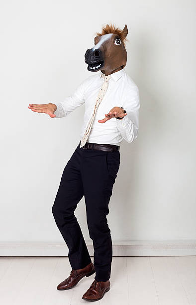 Weird businessman portrait wearing horse head and gesturing Weird businessman portrait wearing horse head and gesturing horse mask photos stock pictures, royalty-free photos & images