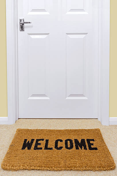 A Welcome doormat in front of a door.