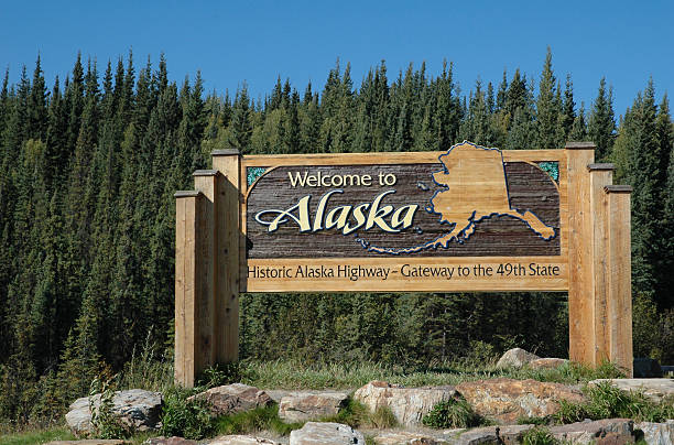 Welcome panel on the Alaska Highway at the Alaskan border stock photo
