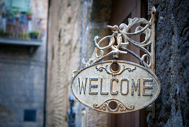 Welcome sign on log home stock photo