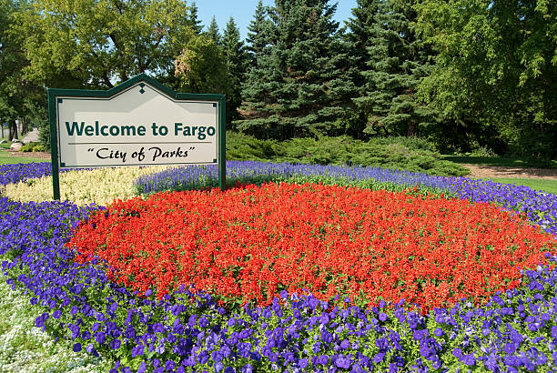 Welcome to Fargo Welcome to Fargo sign in a public garden surrounded by colorful flowers. north dakota stock pictures, royalty-free photos & images