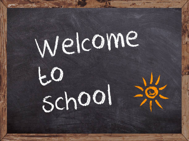 Welcome to school written on a blackboard with wooden frame stock photo