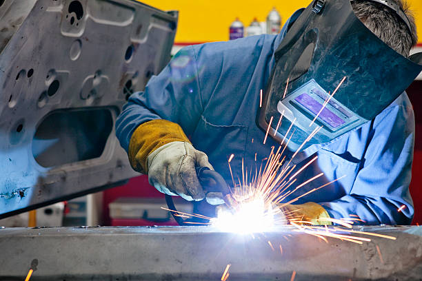 Welder Uses Torch on Car He is Welding  car plant stock pictures, royalty-free photos & images