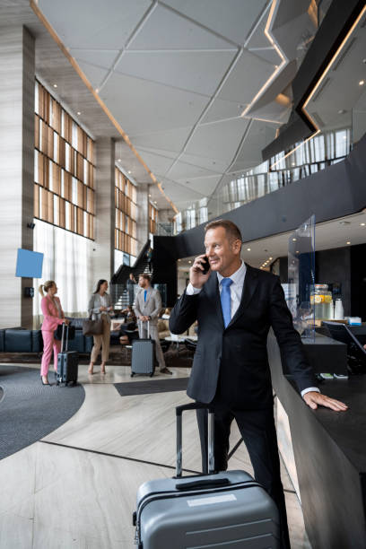 Well dressed businessman talking on the phone in a luxury hotel lobby stock photo