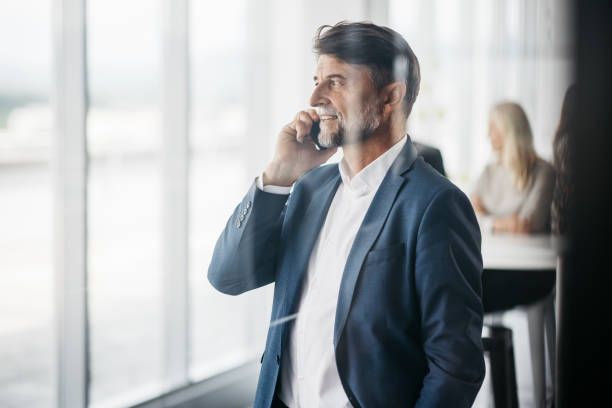 A well-established businessman talking on the phone stock photo