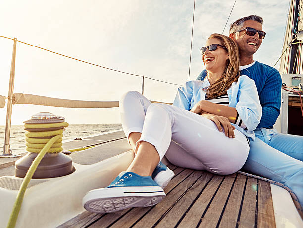We're making memories all over the place Shot of a couple enjoying a boat cruise out on the ocean affluent lifestyles stock pictures, royalty-free photos & images
